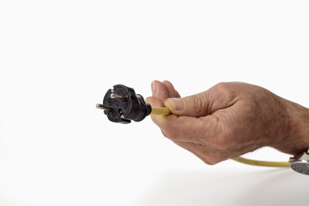 Electric plug holding in hand on white background, close up