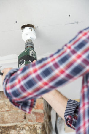 Craftsman working with drilling machine, Freiburg, Germanyの写真素材