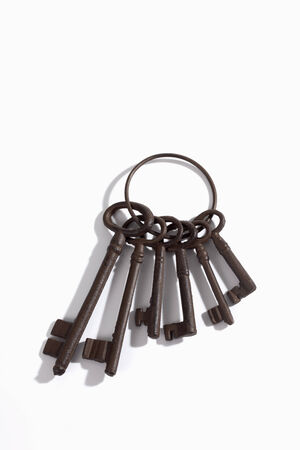 Keyring with old rusty keys on white background