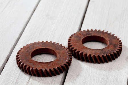 Chocolate cogwheels on wooden background
