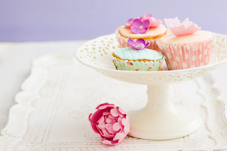 Cupcakes decorated with fondant and gum paste flowerの写真素材