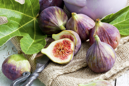 Fresh figs, Ficus carica, old knife on sackcloth