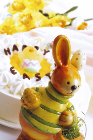 Easter bunny in front of Easter cake