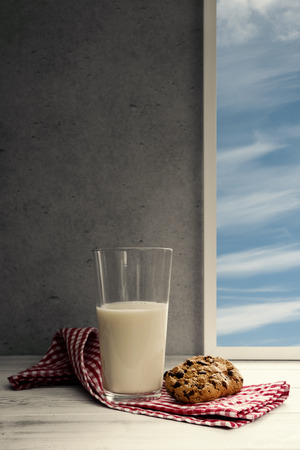 Glass of milk with chocolate cookieの写真素材