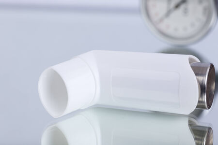 Asthma spray and blood pressure gaugeの写真素材
