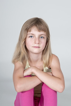 Little blonde girl looking thoughtfulの写真素材