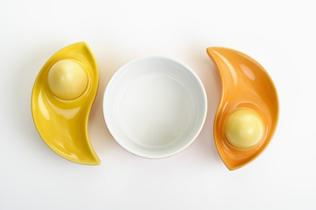 Dyed Ester eggs in colorful ceramic egg cupsの写真素材