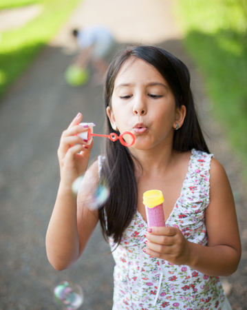 Littel girl making soap bubblesの写真素材