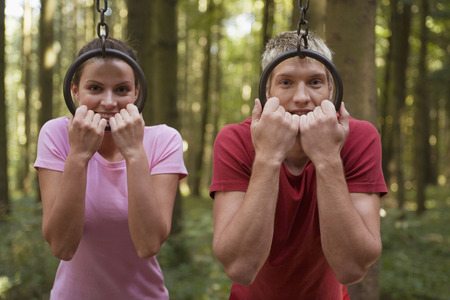 Young couple looking throw rings, smiling,  portrait