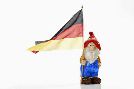 Garden gnome and german flag on white backgroundの写真素材