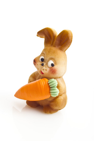 Small marzipan easter bunny with carrotの写真素材