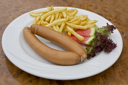 Wiener and french fries on plateの写真素材