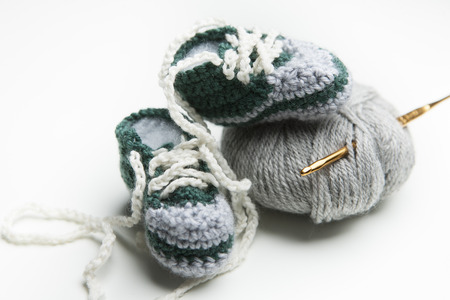 Hand crocheted baby shoes with woolの写真素材