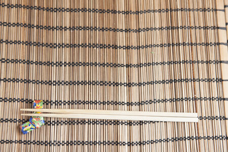 Bamboo chopsticks on a handmade origami chopstick holderの写真素材