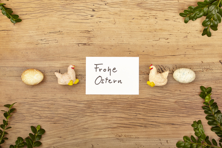 Card Happy Easter, Easter eggs and chicken figurines on woodの写真素材