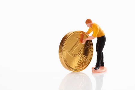 Man figurine moving euro coinの写真素材
