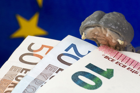 10 Euro note in mouth of a hippo figurineの写真素材