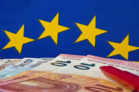 Euro notes and red pencil, EU flagの写真素材