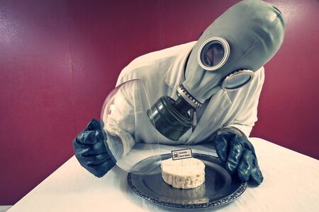 Man in front of a plate with cheese under cheese coverの写真素材