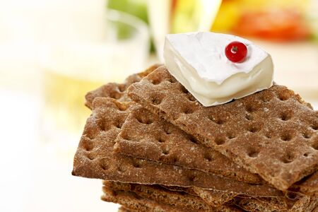 Stacked wholemeal crispbread with soft cheese and currant