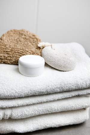 Wellness, white towels with pumice stone, peeling glove and cream jarの写真素材