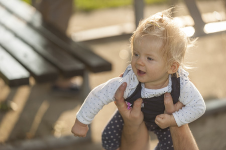 Germany, Leutesdorf, Father holding baby girl up, picnicの写真素材