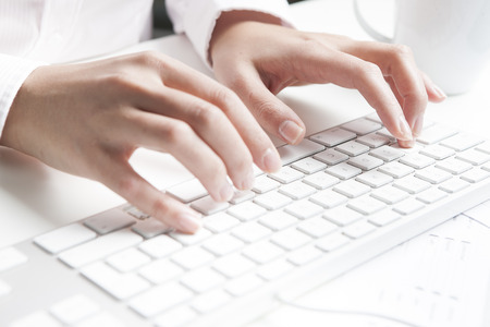 Woman typing on keyboard
