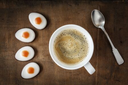 Eastern, Fondant eggs and coffee cup on dark woodの写真素材
