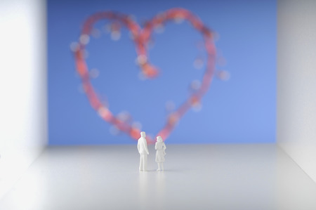 Couple standing against heart.の写真素材