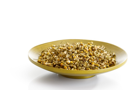 Dried chamomile flower in a bowlの写真素材