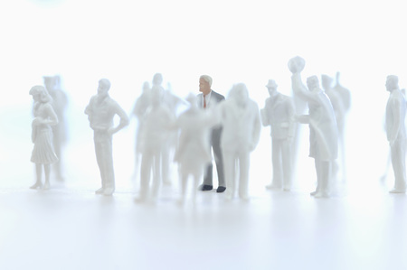 Businessman figurine and silhouettes of figurinesの写真素材