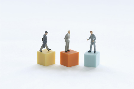 Businesspeople figurines on a podium.の写真素材