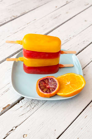 Blood orange and orange ice cream on plate
