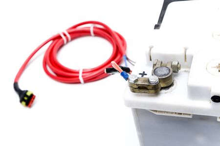 Car battery with charging cable on whiteの写真素材