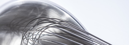 Wire whisk and bowl, steel, close up, white backgroundの写真素材