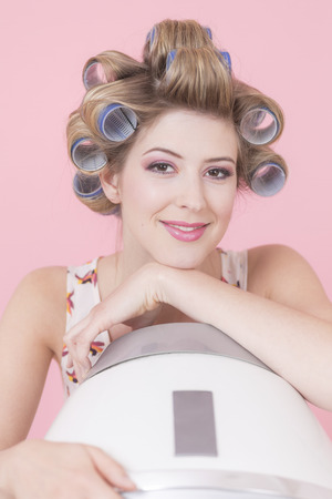 Young woman with curlers, hood drierの写真素材