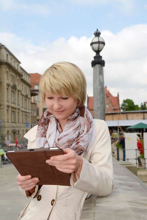 Young woman using digital tablet, Berlin, Germanyの写真素材