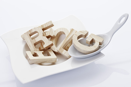 Alphabet soup, wooden letters on soup plateの写真素材