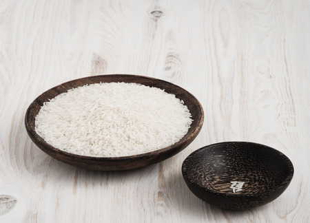 Unboiled rice distributed  in wooden bowlsの写真素材