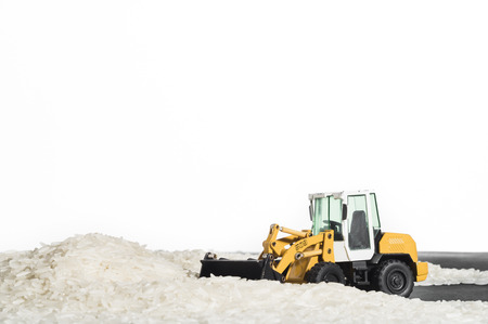Toy digger on pile of rice, staple, distribution, tradeの写真素材