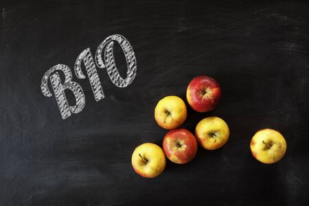 Apples and word bio written with chalk on black boardの写真素材