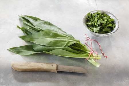 Chopped ramson in bowl with ramson and knife