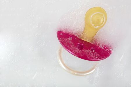 Social freezing, pacifier on iceの写真素材