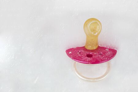 Social freezing, pacifier on iceの写真素材