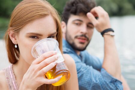 Couple drinking beer in summerの写真素材