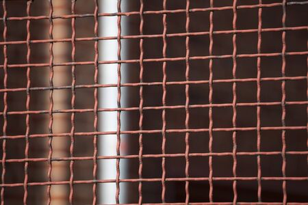 Fence, grid of iron in front of windowの写真素材