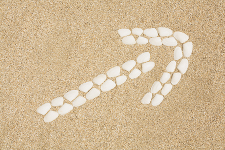 Arrow sign made from seashellsの写真素材