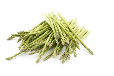 Pile of green asparagus on white backgroundの写真素材