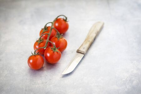 Cherry tomatoes and knifeの写真素材