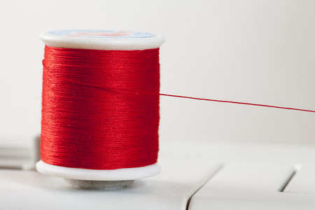 Bobbin, red yarnの写真素材